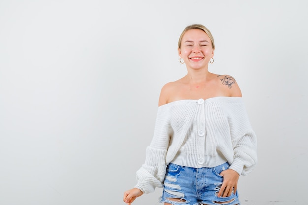 Young blonde woman in a white cardigan