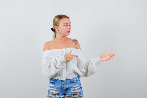 Free photo young blonde woman in a white cardigan