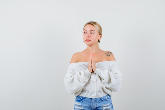 Young blonde woman in a white cardigan