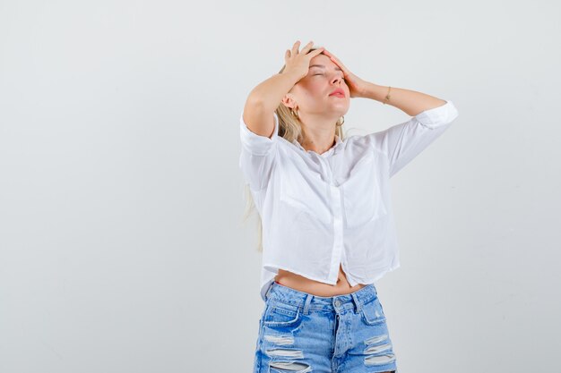 Young blonde woman in a white shirt