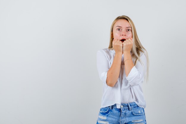 Young blonde woman in a white shirt