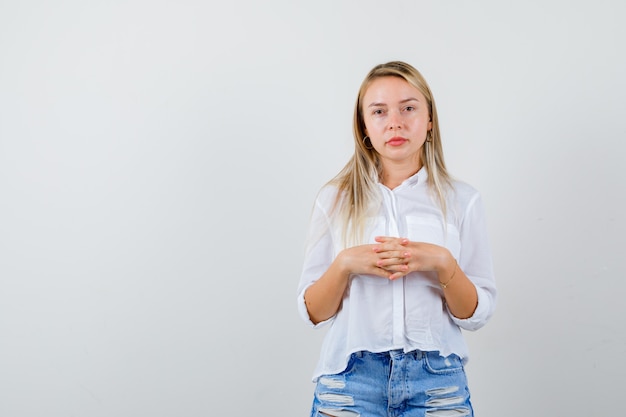 Young blonde woman in a white shirt