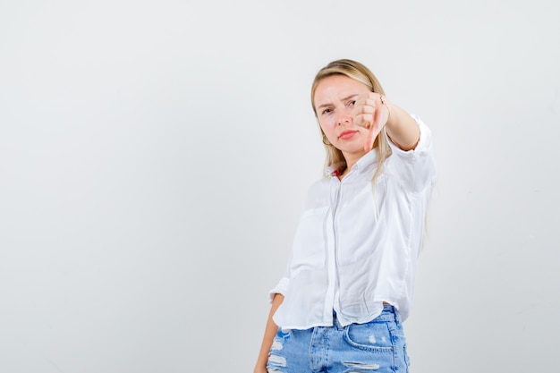 Young blonde woman in a white shirt