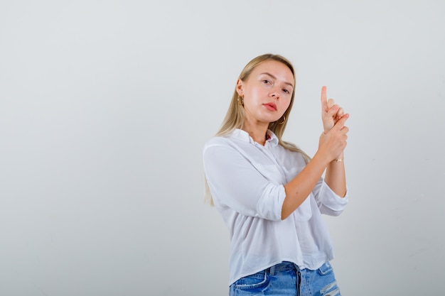 Young blonde woman in a white shirt