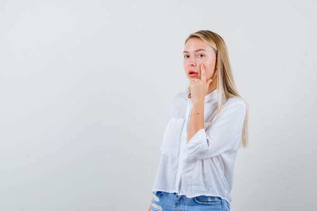 Young blonde woman in a white shirt