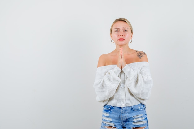 Young blonde woman in a white sweater