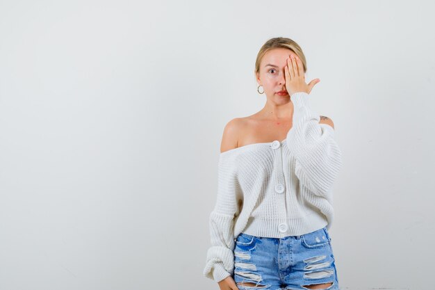 Young blonde woman in a white sweater