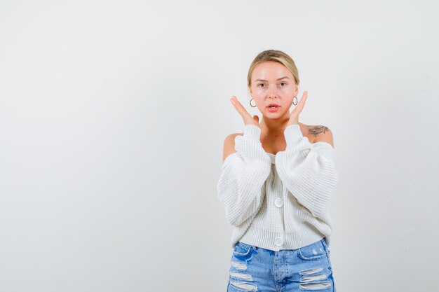 Young blonde woman in a white sweater