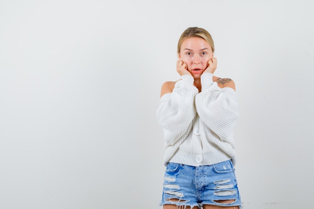 Free photo young blonde woman in a white sweater