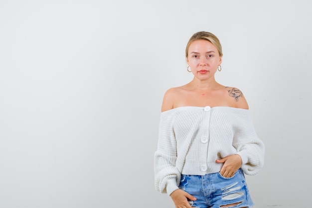 Free photo young blonde woman in a white sweater