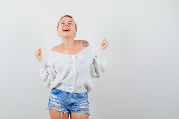 Giovane donna bionda con un maglione bianco