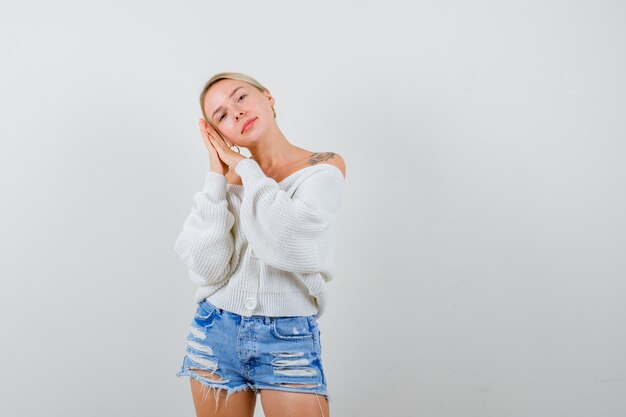 Young blonde woman in a white sweater