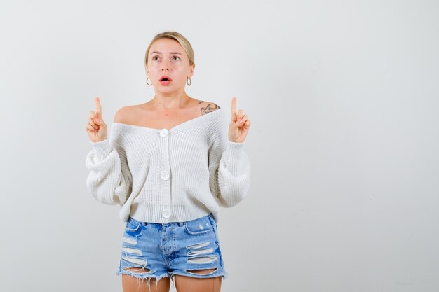 Young blonde woman in a white sweater