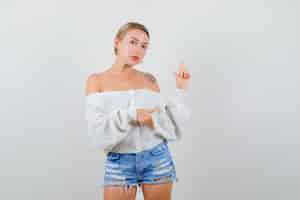 Free photo young blonde woman in a white sweater