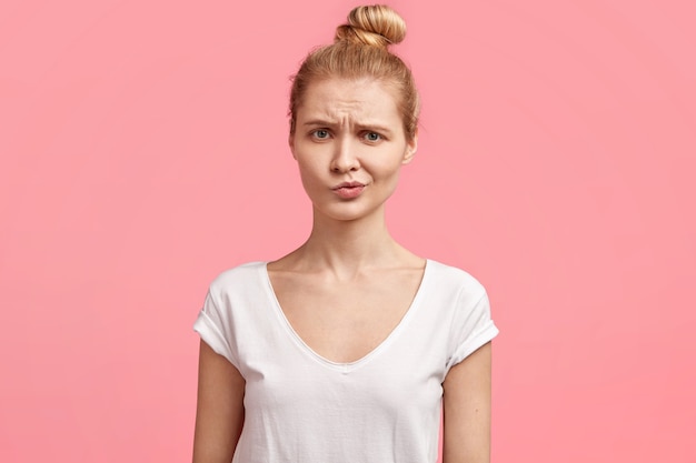 Free photo young blonde woman with hair in a bun