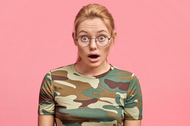 Young blonde woman with round glasses