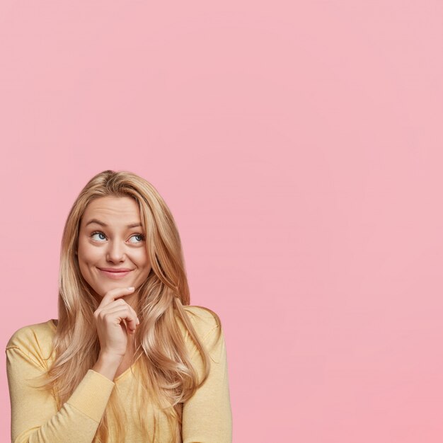 Young blonde woman with yellow sweater