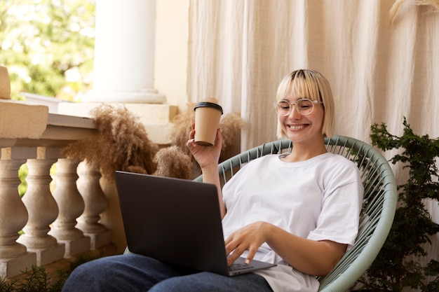 Young blonde woman working from home in her chair