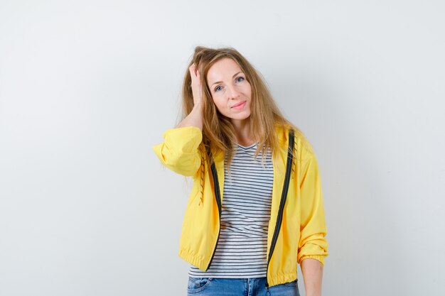 Young blonde woman in a yellow jacket