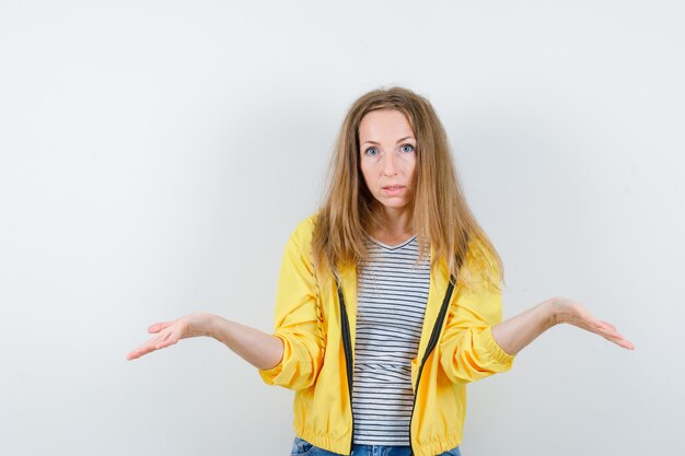 Young blonde woman in a yellow jacket