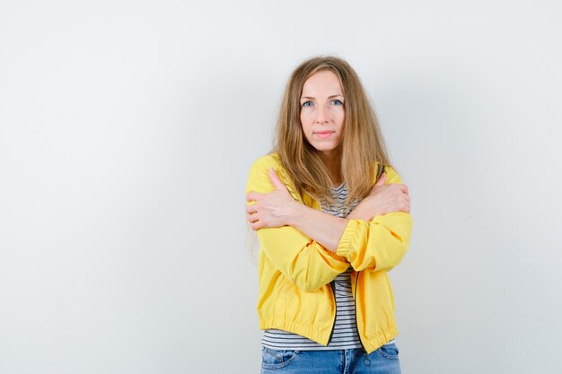 Young blonde woman in a yellow jacket