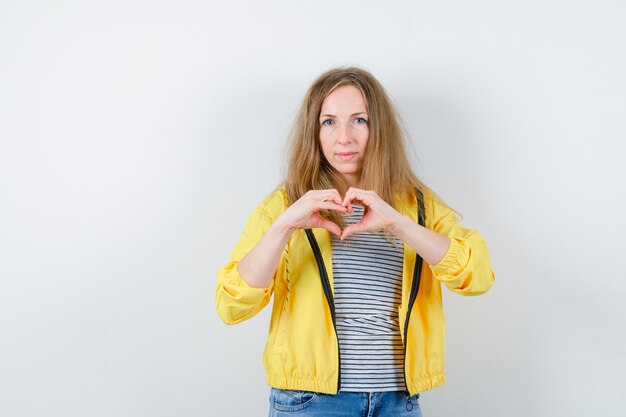 Young blonde woman in a yellow jacket