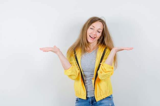 Young blonde woman in a yellow jacket