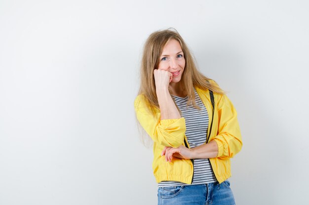 Young blonde woman in a yellow jacket