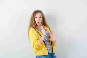 Free photo young blonde woman in a yellow jacket