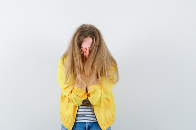 Free photo young blonde woman in a yellow jacket