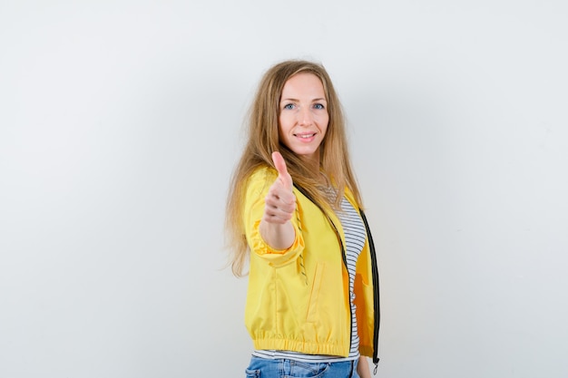 Young blonde woman in a yellow jacket