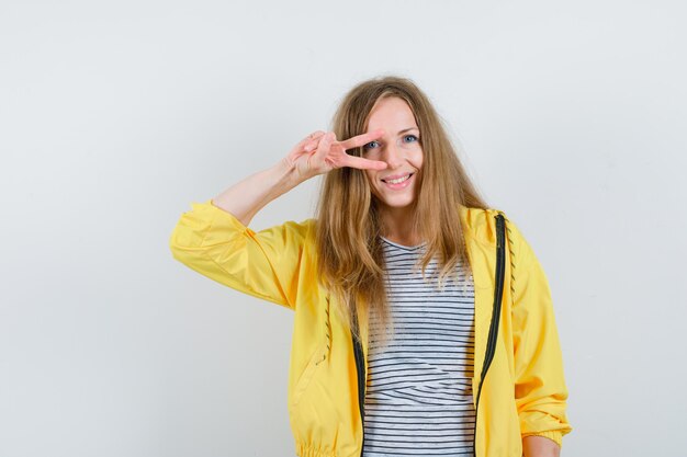 Young blonde woman in a yellow jacket