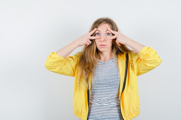 Young blonde woman in a yellow jacket