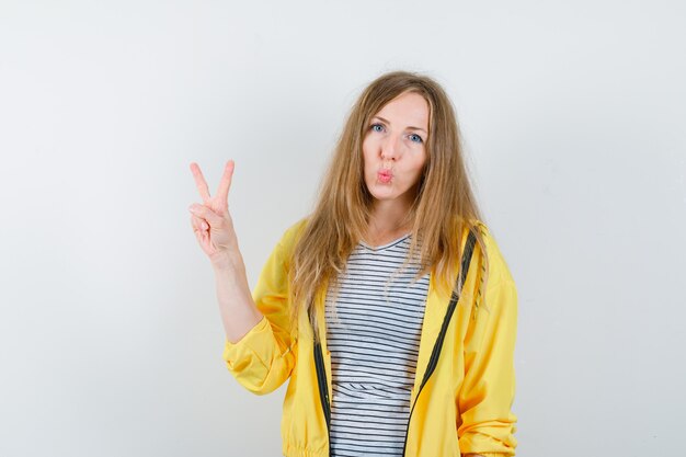 Young blonde woman in a yellow jacket