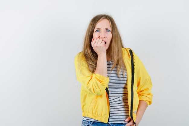 Young blonde woman in a yellow jacket