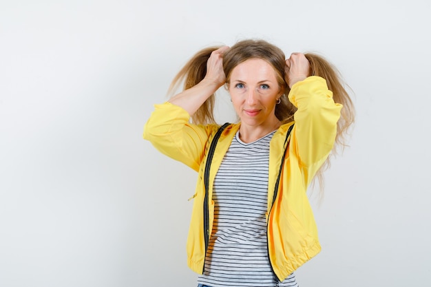 Free photo young blonde woman in a yellow jacket