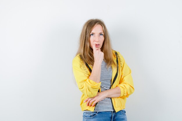 Young blonde woman in a yellow jacket