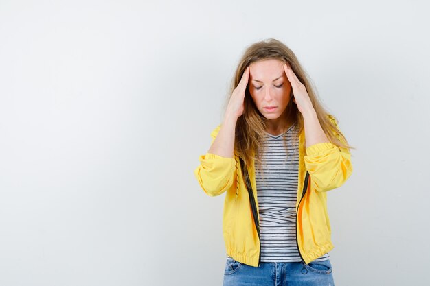 Young blonde woman in a yellow jacket