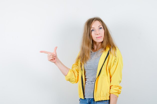 Young blonde woman in a yellow jacket