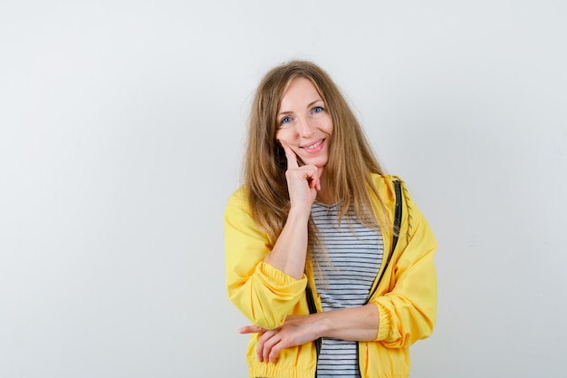 Young blonde woman in a yellow jacket