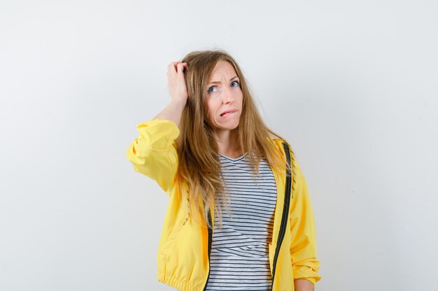 Young blonde woman in a yellow jacket