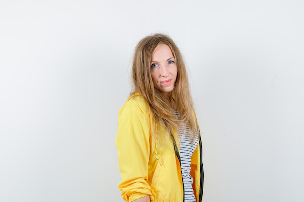 Free photo young blonde woman in a yellow jacket