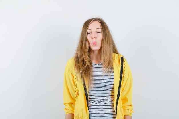 Young blonde woman in a yellow jacket