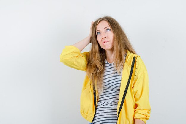 Young blonde woman in a yellow jacket