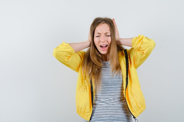 Young blonde woman in a yellow jacket