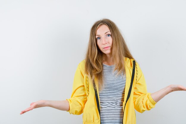 Young blonde woman in a yellow jacket