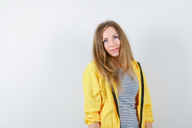 Young blonde woman in a yellow jacket