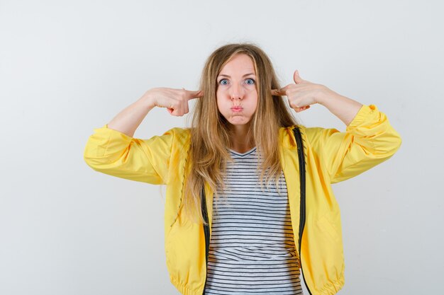 Young blonde woman in a yellow jacket