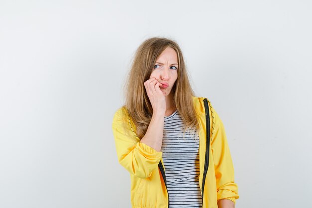 Young blonde woman in a yellow jacket