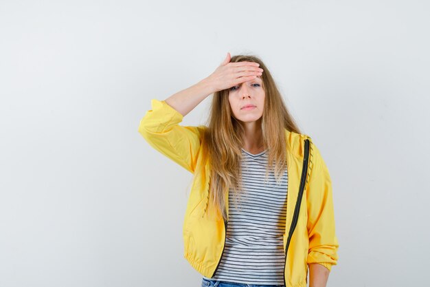 Young blonde woman in a yellow jacket